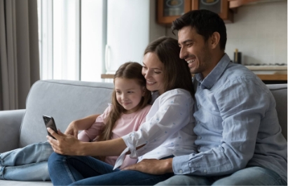 Child together with parents looking at smartphone